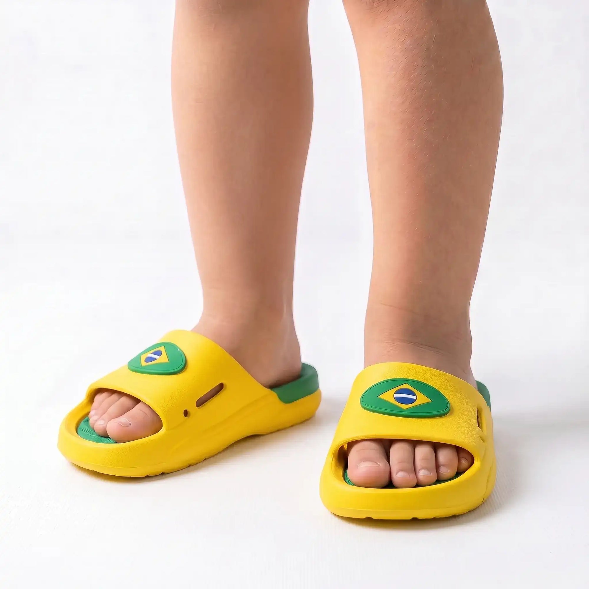 Criança usando chinelo slide nuvem infantil brasil bandeira verde amarelo — look torcida Copa 2026 VAI DAR BRASIL