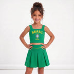 Menina vestindo conjunto infantil saia plissada cropped brasil brasão verde — look Copa 2026 VAI DAR BRASIL charme elegante